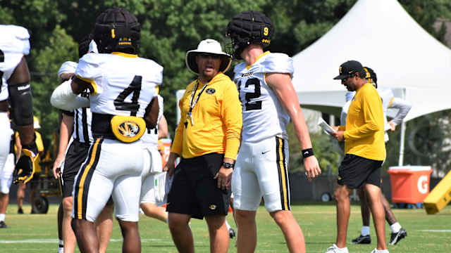 Missouri head coach Eli Drinkwitz talks with quarterback Brady Cook (12) during a preseason practice on August 7, 2022.